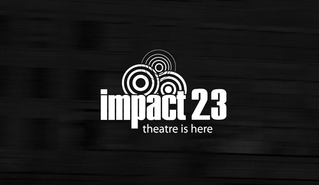 White IMPACT23 logo on dark blurry background, teaser for the IMPACT23 festival launch.