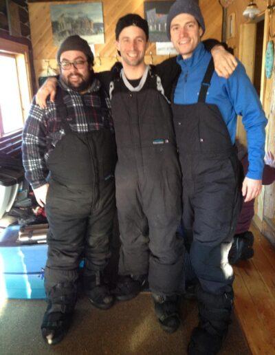 Majdi Bou-Matar, Trevor Copp, Brad Cook posing for camera while wearing snowpants