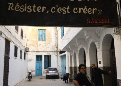 Majdi posing under the entrance of the courtyard of El Hamra Theatre in Tunis