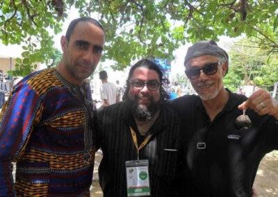 Majdi with two actors from the Raft posing for the camera, as the person on the right holding a fig