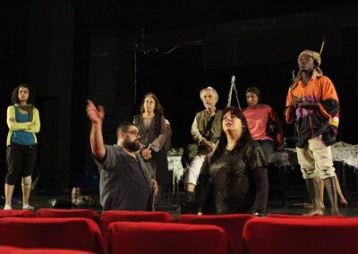 Majdi directing the cast of the Raft on stage