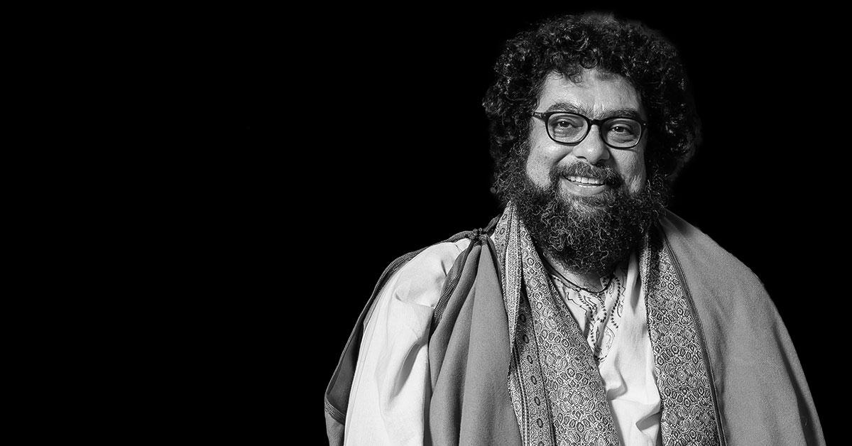 MT Space's found artistic director Majdi Bou-Matar smiling on black background