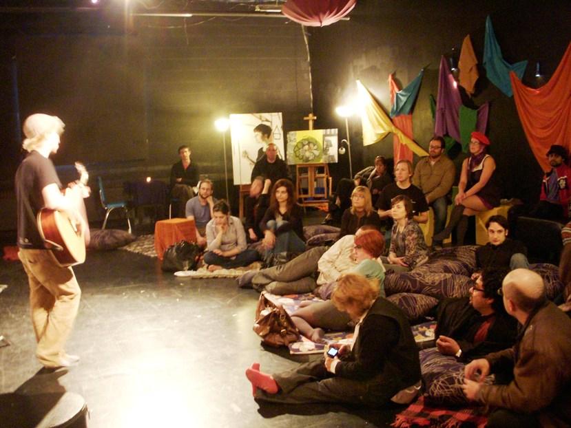 Throwback to early MT Space Tell arts and community event, year unknown, with audience sitting on floor cushions.