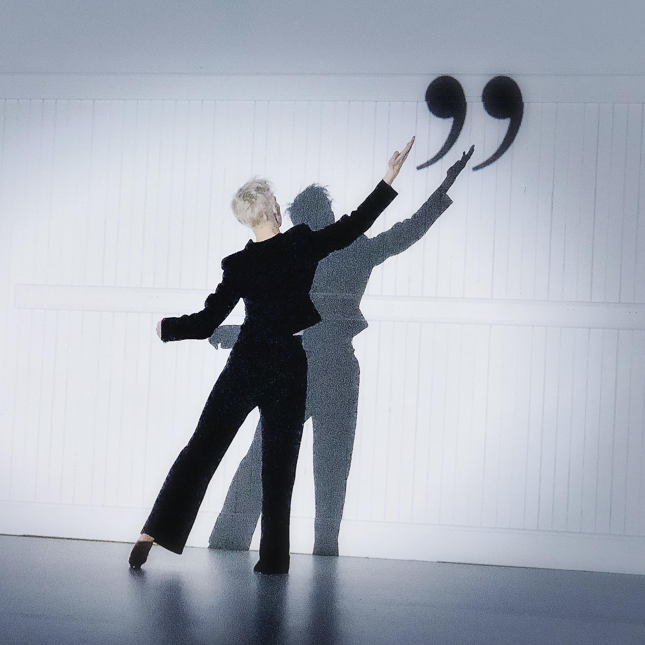 Woman reaching up to a quote symbol 